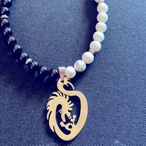 Black obsidian beads with white marble. Stainless steel clasp & pendant